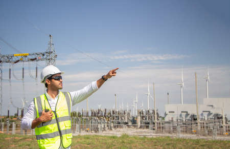 engineer team working in wind turbine farm. Renewable energy with wind generator by alternative energy concept.の写真素材