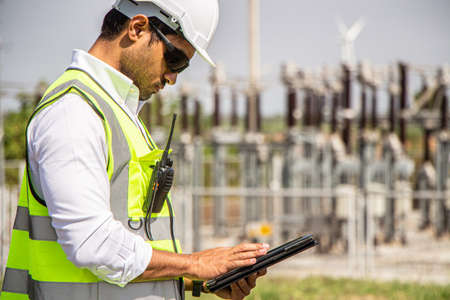engineer team working in wind turbine farm. Renewable energy with wind generator by alternative energy concept.の写真素材