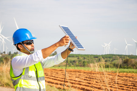 engineer team working in wind turbine farm and solar cell. Renewable energy with wind generator by alternative energy concept.の写真素材
