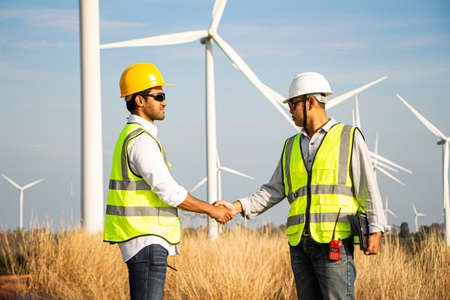 engineer team working in wind turbine farm. Renewable energy with wind generator by alternative energy concept.の写真素材