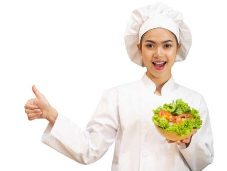 Asian woman in chef's uniform is cooking in the kitchenの写真素材