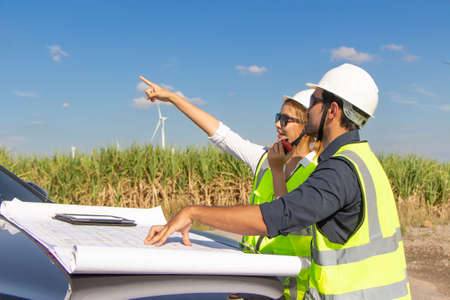 engineer team working in wind turbine farm. Renewable energy with wind generator by alternative energy concept.の写真素材