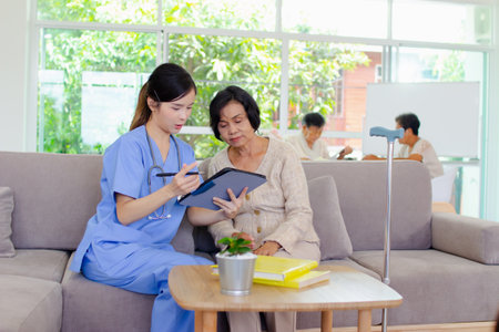 Nursing Home Care concept. The staff explained to the elderly who signed a medical treatment contract, a nursing home service agreement form.の写真素材