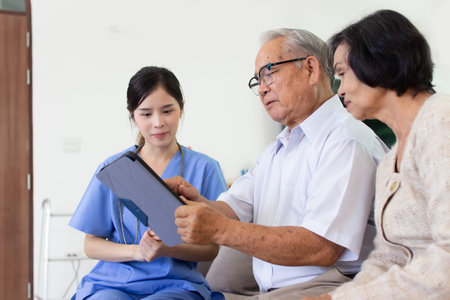 Nursing Home Care concept. The staff explained to the elderly who signed a medical treatment contract, a nursing home service agreement form.の写真素材