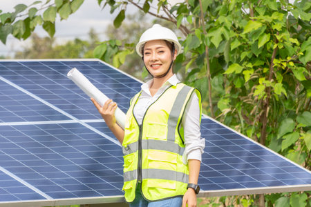 Female Manager Engineer Ä°n Safety Helmet Checking With Tablet An Operation Of Solar Panel System At Solar Stationの写真素材