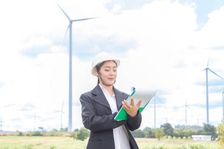 Young Asian businesswoman in suit with electric turbine as background.の写真素材