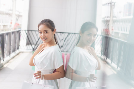 Beautiful asian woman with shopping bags in shopping mall, lifestyle concept.の写真素材