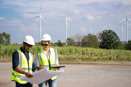 engineer and engineer with wind turbine power generator in wind turbine farmの写真素材