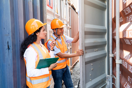 Portrait of female engineer and male supervisor checking cargo containers at the container yardの写真素材