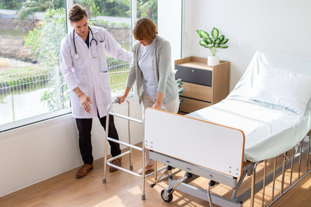Doctor assisting senior patient in hospital ward at the hospital. Medical healthcare and doctor staff service concept.の写真素材