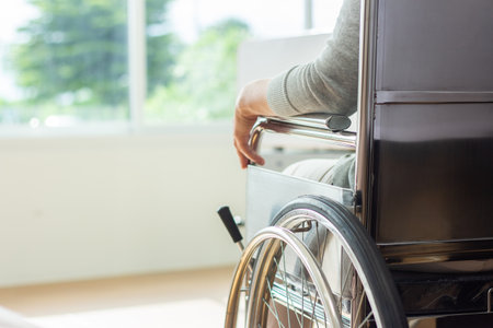 Close up of a disabled man in a wheelchair at the hospital.の写真素材