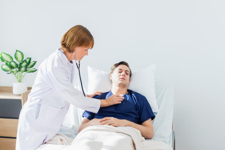 Doctor examining sick patient in hospital bed. Healthcare and medical service.の写真素材
