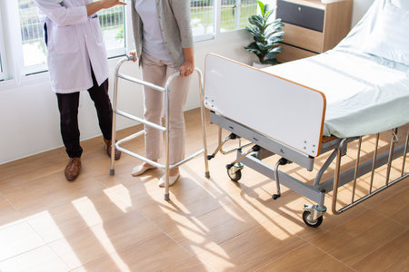 Doctor and patient discussing something while standing in hospital ward. Medical and healthcare concept.の写真素材