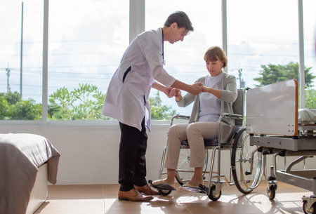 Doctor and patient shaking hands in hospital room. Healthcare and medical services.の写真素材