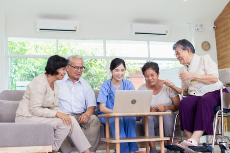 Senior people using laptop in living room at home. Senior people and health care concept.の写真素材