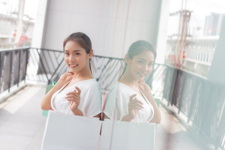 beauty asian woman with shopping bag in mall, lifestyle conceptの写真素材