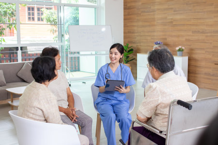 asian nurse talking with senior patient at nursing home or emergency roomの写真素材