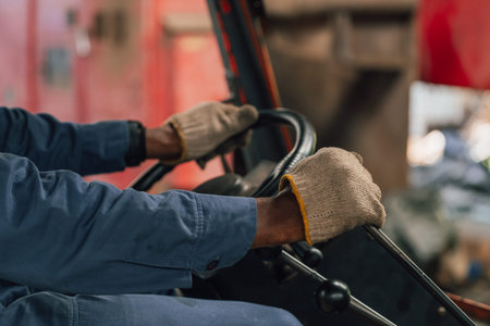 Close-up of forklift driver working at warehouse. Selective focus.