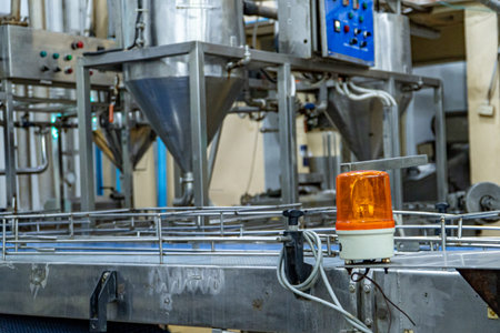 Female industrial engineer wearing a white helmet while standing in a heavy industrial factory.の写真素材