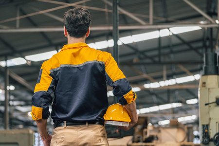 Caucasian engineer using a laptop in a factory. man working in plastics factory.