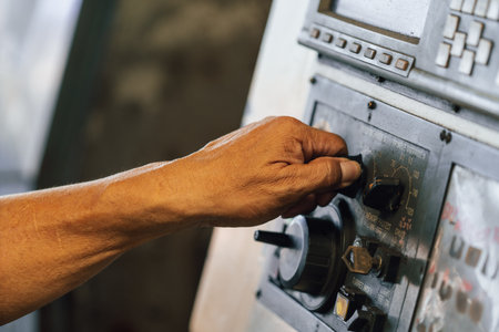 Man's hand pressing button on the control panel of the radio.の写真素材