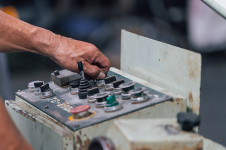 Man working on control panel of industrial machine. Selective focus.の写真素材