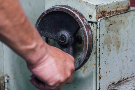 hand of a worker on a lathe machine, close-upの写真素材