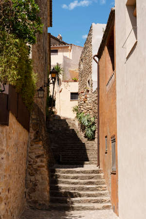 A narrow street among the old houses of Alcudia, Mallorca, Spainの写真素材