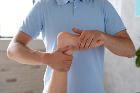 Man suffering from wrist pain in office, closeup. Health careの写真素材