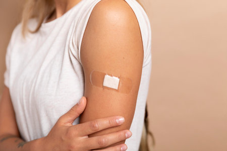 Woman with adhesive bandage on arm, closeup. Vaccination conceptの写真素材
