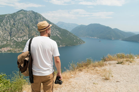 Man with a camera on the shore of Lake Garda, Italy