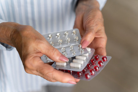 Close-up Of Senior Woman Holding Pills And Capsules In Pack