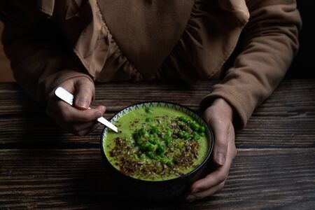 Pea soup on wooden backgroundの写真素材
