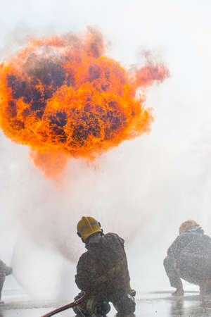 Firemen in a fire-fighting training exerciseの写真素材
