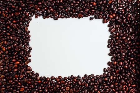 Roasted coffee beans isolated on white with copy space for textの写真素材