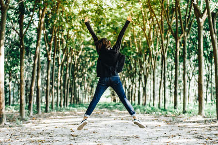 Happy woman is jumping on parkの写真素材