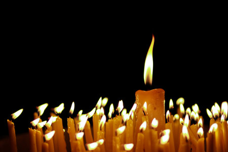 candle flames glowing in the dark.