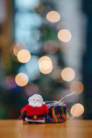 Santa Claus dolls and Christmas decorations box on abstract lightの写真素材