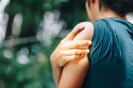 Woman with pain in shoulder and upper arm. Office syndrome concept.の写真素材