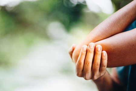 female's elbow. Arm pain and injury concept. woman with painful elbowの写真素材