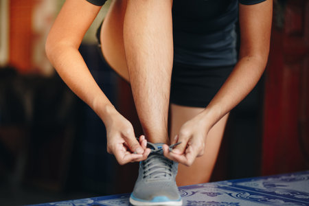 young woman runner tying shoelaces . Sport lifestyle.