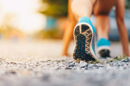 Sport. Runner feet running on road close up on shoe.の写真素材