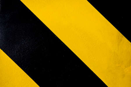 Industrial striped road warning yellow-blackの写真素材