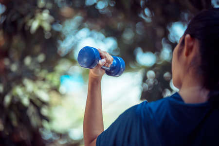 Woman lifting dumbbells . Sport and Lifestyle Conceptの写真素材