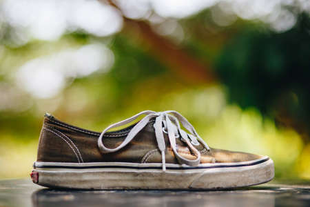 Old black sneakersの写真素材