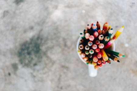 colored pencils in a glass on backgroundの写真素材