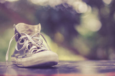 Old shoes black sneakers with bokeh backgroundの写真素材