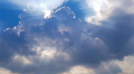 Beautiful blue sky with sunbeams and clouds. Sun rays.の写真素材