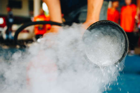 use a fire extinguisher to fire at the gas tank.の写真素材