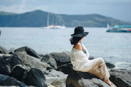 woman on beach. She is enjoying serene ocean nature during travel holidays vacation outdoorsの写真素材